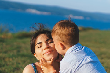 Wall Mural - boy kissing mother on cheek