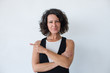 © Mangostar - Content woman pointing with finger. Beautiful middle aged woman pointing away with finger and smiling at camera. Gesture concept