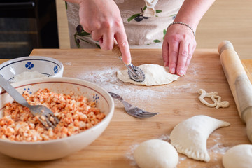 Close up of female hands preparing panzerotto, typical street food of Puglia