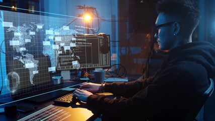 Poster - cybercrime, hacking and technology concept - asian male hacker in dark room writing code or using computer virus program for cyber attack