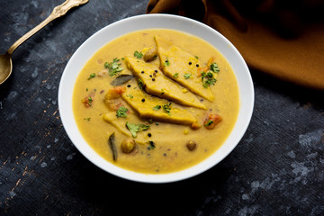 Dal Dhokli, Varan Phal or Chakolya is a gujarati, Rajasthani and maharashtrian dish made using diamond shape wheat flour cakes boiled in a dal. It's an easy one pot meal. served in a bowl.