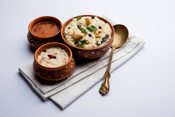 Wall Mural - Ven pongal recipe is a popular South Indian food prepared with rice & moong dal and served with sambar and coconut chutney, selective focus