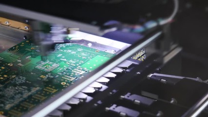 Poster - Electronic circuit board close up. Media. Process of creating an electronic chip. Automatic operation of the robot to create an electronic chip