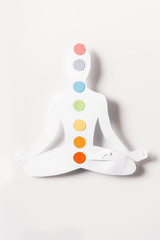 Sticker - top view of paper figure in form of person with chakras in lotus pose on white