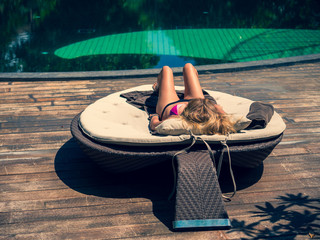 Wall Mural - Beautiful woman relaxing by poolside