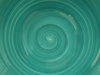  the bottom of the plate is turquoise in color with a swirl pattern