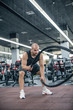 © Roman - Man with battle rope battle ropes exercise in the fitness gym.