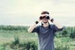 © Andreshkova Nastya - Portrait of young adventure man travelling with binoculars, watching landscape view outdoors. Young brunette man discover nature scenes. Travelling, discovering, vacation concept
