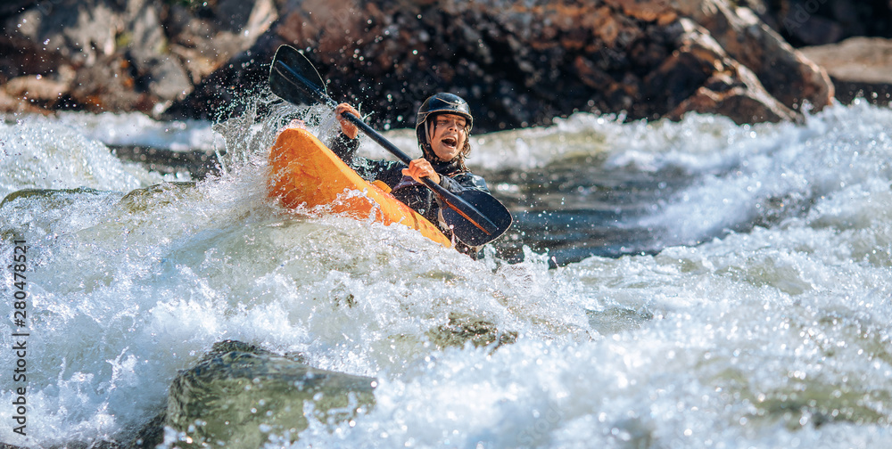 Guy in kayak sails mountain river. Whitewater kayaking, extreme sport rafting - obrazy, fototapety, plakaty 