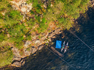 Wall Mural - Guy in kayak sails mountain river. Whitewater kayaking, extreme sport rafting. Aerial top view