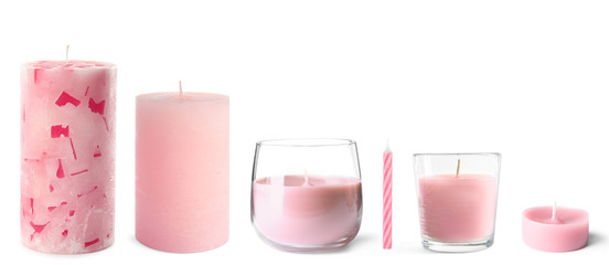 Set with different pink candles on white background