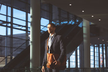 Businessman With Office Bag Looking Away In A Modern Office Building