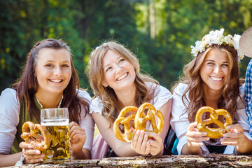 Five friends having fun on Bavarian RIver and clinking glasses with beer