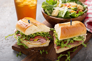 Wall Mural - Italian meat sandwich with salad and chips for lunch