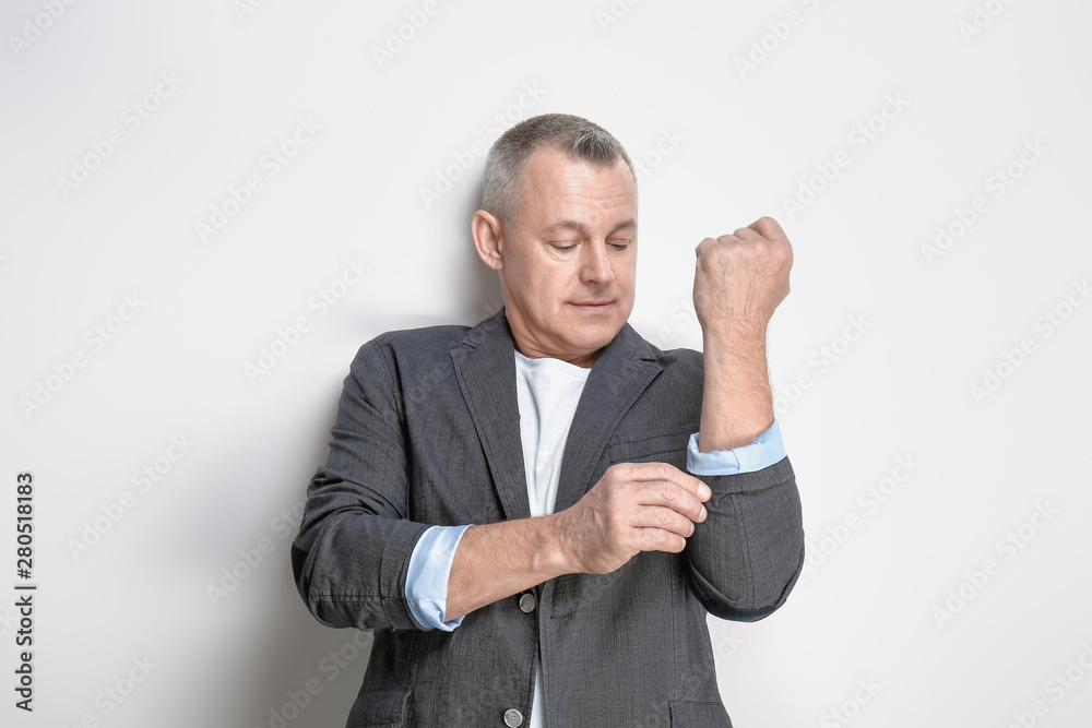 Portrait of handsome middle-aged man on light background