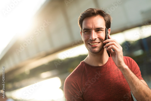 Sportsman having a friendly chat over his cellphone