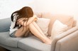 © topten22photo - Asian woman with severe migraine headache holding hands to head on white background..