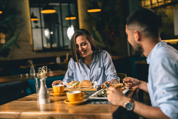 Wall Mural - A happy young couple having dinner at a fancy restaurant