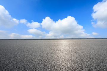 Asphalt road and blue sky with white clouds landscape