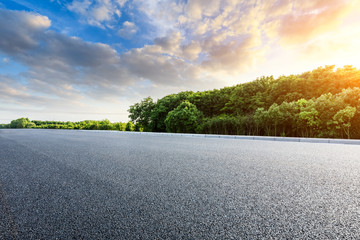 Asphalt highway and green forest with beautiful cloud landscape at sunset