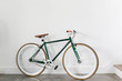 © Deidre - Fixed Green and Brown Bicycle in Modern Home, Fixie Bike inside hous​e, white wall background, isolated retro bicycle