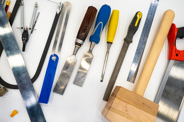 Poster - Carpentry tools on a white table. The working tools of a carpenter. Equipment carpentry. Woodworking. Furniture manufacturing.