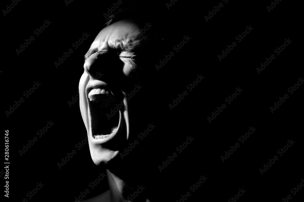 black and white photo on a black background, distorted face screaming - obrazy, fototapety, plakaty 
