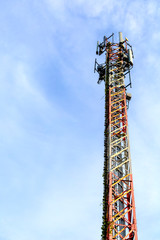 mobile phone communication and network signal repeater antenna tower with blue sky background