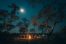 Tourists Resting Around Campfire, Botswana
