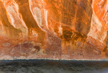 Sandstone Cliff Canyon Wall  In Colorful Shades Of Red, Orange, And Yellow Above A Clear Stream - Oak Creek, Sedona, Arizona