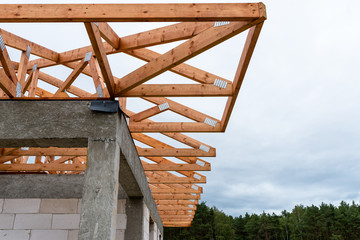 Wall Mural - Roof trusses not covered with ceramic tile on a detached house under construction, visible roof elements, battens, counter battens, rafters.