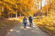 © Bogdan - Two elderly people walking in the autumn forest