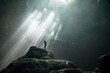 © Sergey Lukankin/Stocksy - Girl stands under the rays of light in a deep cave Jomblang Cave. Java, Indonesia