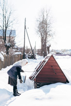 Woman Taking Water From Well In Winter