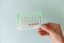 Woman Holding Pack Of Birth Control Pills