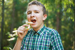 © goldeneden - teenager boy with mushroom in the forest in summer day