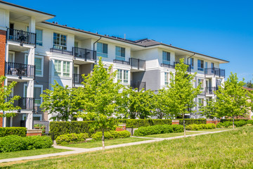 Luxury apartment building with green lawn in front