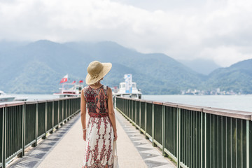 traveling Asian woman with hat