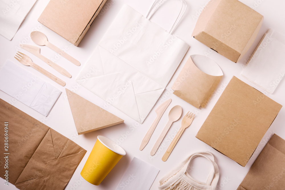 Top view and flat lay concept of Eco friendly, kraft, disposable, recyclable tableware. Paper food boxes, dishes on white background - obrazy, fototapety, plakaty 