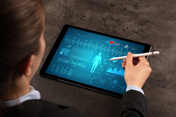 Wall Mural - Business woman making healthy analysis on tablet