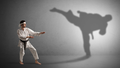 Canvas Print - Young karate man confronting with his own shadow