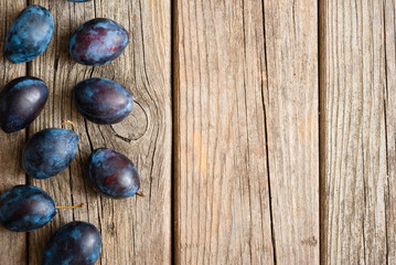 Canvas Print - plums on old wood table directly above