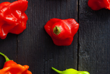 Canvas Print - chili peppers on black wood table