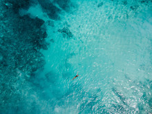 Aerial View Woman In Lack  Bikini Lying On Transparent Turquoise Water Surface On Beach