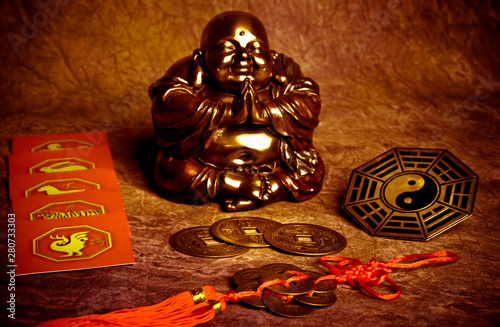 Fotografía Oriental belief with happy Buddha, coins of good luck, yin yang and chinese zodi