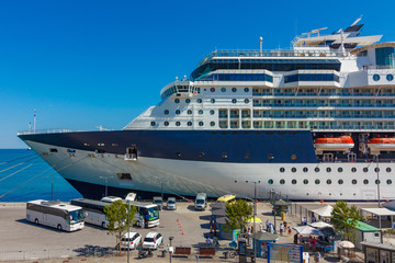 A large luxury cruise liner moored in the port of the Adriatic Sea, is waiting for passengers. There are four orange lifeboats abroad of a cruise ship in Koper, Slovenia.