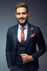 Stylish young man in suit and tie. Business style. Fashionable image. Office worker. Sexy man standing and looking at the camera