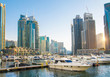 © IRStone - Dubai, UAE United Arabs Emirates. Dubai marina skyscrapers and yachts at sunset. Apartments, hotels and office buildings, modern residential development of UAE