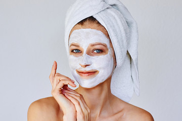 Wall Mural - beautiful woman applying facial mask on her face. skin care and treatment, spa, natural beauty and c