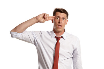 Portrait of a young brunet man posing in a studio isolated over a white background.